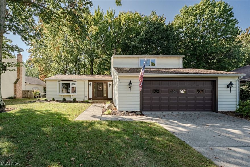 Move right into this beautiful split-level home on a quiet street in Westlake. This well-kept home has been lovingly maintained and updated by the original owners and is now ready for a new owner! Highlights include gleaming woodwork, abundant natural light, a tastefully updated kitchen, spacious living areas, and more! The front door opens into a welcoming foyer with that flows into the living room. Here you will find a soaring vaulted ceiling and a delightful bay window. Custom wood columns provide an elegant transition to the equally bright and sunny dining room. The eat-in kitchen includes a full complement of stainless steel appliances, a lovely tile backsplash, a bay window above the sink, and a generous dining area. Step down to a fabulous family room that boasts a brick fireplace with a gas insert flanked by built-in shelving. Off of the family room there is a laundry / mud room, a convenient half bath, and a spacious bedroom with deep closet that is currently setup as a cozy office. Upstairs, there are three additional bedrooms, including the primary suite. Here you will find a very spacious bedroom with hardwood flooring, an ensuite full bath, and a walk-in closet. A second, updated full bath completes the second floor. The lower level could easily be finished if desired. Outside, there is a tranquil back patio with a built-in gas fire pit and gas bbq, plus a deep wooded back yard. Fantastic location just minutes from schools and shops! Don't miss this one!