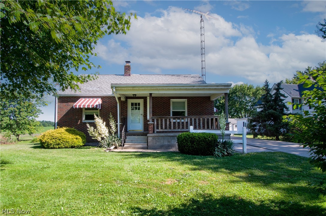 Charming Brick Bungalow on .62 Acres - Two parcels -Three Bedrooms – 1,496 Sq Ft - Marlington Schools. Country Living Minutes From #62. The main floor offers an inviting covered front porch that leads you into the spacious living room. A Kitchen with (stainless appliances/plenty of cabinet & counter space) and a pass-through window to the dining area. Two bedrooms and a full bath with a shower tub combo & built-in drawers/linen closet. The second level has a large third bedroom with hardwood flooring and a sitting area. The basement has a gas fireplace, a walk-in shower, a laundry area, glass block windows, built-in shelves, and abundant storage space. An expansive driveway leads to a nice 2.5-car garage (30' x 24') and a 14' x 12' storage shed—a large lot with a deck and privacy is perfect for enjoying peaceful countryside feel. New septic installed 8-2022. Make an appointment for your private showing today! New septic installed 8-2022