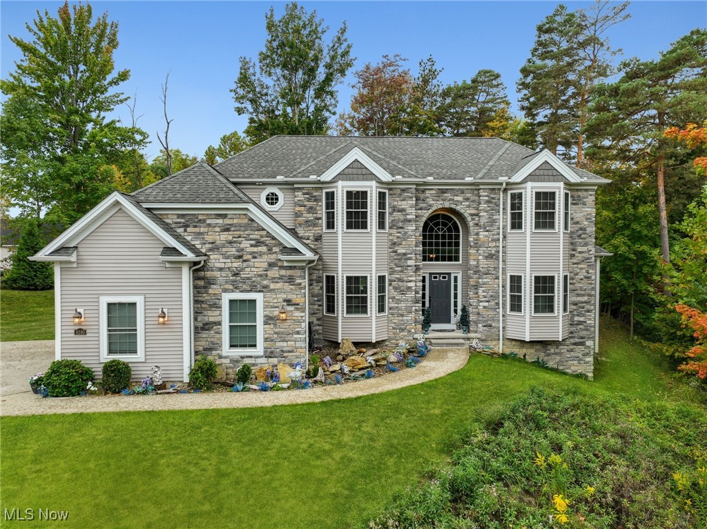 Welcome to this stately home in North Royalton, tucked away at the end of a quiet cul-de-sac, yet only MINUTES to major expressways (71, 77, 480), downtown, the airport, and endless shopping centers! Designed with high ceilings, detailed millwork, and an abundance of natural light, this residence offers a perfect blend of style and comfort.
A formal dining room features a bay window and tray ceiling, providing an elegant space for intimate dinner parties.
The two-story living room features a dramatic stone fireplace, floor-to-ceiling windows, views of the upstairs catwalk, and a coffered ceiling, creating a warm and inviting centerpiece for gatherings.
Prepare culinary delights in the gourmet kitchen, equipped with granite countertops, stainless steel appliances, an expansive center island/breakfast bar, pantry, and an eating area with patio access.
Retreat to the luxurious, first floor primary suite, complete with a cozy fireplace, distinctive tray ceiling, walk-in closet, and spa-like ensuite with double sinks and a private commode area.
A convenient laundry room and guest bathroom complete the main level.
Upstairs, you’ll find three spacious bedrooms, a loft, and a full bathroom with double vanities and a separate shower/commode space.
The finished lower level is a showstopper with a recreation/fitness area, bar area, recessed lighting, and garden windows. It is also rough plumbed for an additional bathroom.
Enjoy the expansive, stamped concrete patio overlooking the .62-acre yard with a serene, wooded backdrop and peaceful, panoramic views of mature trees! Listen to the tranquil creek while watching cute wildlife visitors on this private lot!
Located in the highly regarded North Royalton School District, this sprawling home offers the perfect combination of comfort, convenience, and sophistication.