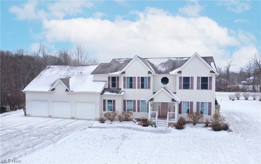 Fabulous custom built colonial (by J & M Salupo) nestled on 2.7 acres presents an open floor plan and spacious living areas.  9 ft. ceilings throughout the first floor.  Covered front porch leads to a two story foyer with tile floors and view of rooms beyond.  Engaging great room highlights a wood burning fireplace with raised hearth and flanked by double windows. Gourmet kitchen offers island/breakfast bar, newer SS appliances, granite, backsplash, pantry, and large separate eating area with access to covered deck.  Formal dining room and formal living room off the foyer.  French doors to first floor office/den with bright light. Guest bath conveniently located nearby.  Laundry room offers ample cabinetry with extended counter and access to full walk-in shower and water closet.  Second floor owners suite showcases glamour bath with Jacuzzi tub, separate vanities, and H/H walk-in closets.  An additional four, generous sized bedrooms, Jack-n-Jill bath, main full bath, and a massive bonus room/family room complete the second story.  The lower level boasts 14 course, 4 glass block windows, and is ready for finishing by the discernible buyer.  Notable amenities include 2 furnaces (2021), 2 A/C's (2021), 75 gallon hot water tank (2019), Pella windows and slider, 200 amp in garage. Outbuilding. Level yard. Blueberry bushes.  Lot extends 20' at rear property line into woods and 30' at side yard into woods.  Revere Schools.