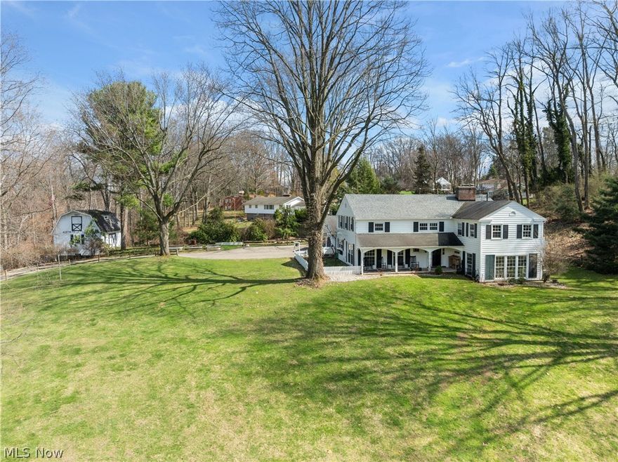 Nestled atop a private, wooded hilltop on nearly three acres, this stunning farmhouse epitomizes country elegance, seclusion, and modern sophistication. A welcoming covered front porch leads into a light-filled foyer framed by oversized floor-to-ceiling windows, flowing seamlessly into the great room and dining area. The great room exudes warmth and character with a woodburning fireplace, striking beamed ceilings, and direct access to a screened porch overlooking the serene wooded setting—perfect for quiet mornings or entertaining guests. The heart of the home, a grand fully remodeled kitchen, is designed for both function and gatherings, featuring a spacious island, farmhouse sink, pot filler, beverage cooler, and abundant storage. An oversized office with a second fireplace, built-in bookshelves, and beamed ceilings provides a luxurious space for work, reading, or study. Upstairs, the owner’s suite offers a serene retreat with a beautifully remodeled full bath, complemented by a showstopper second-floor laundry room and walk-in closet. Three additional generous bedrooms and a full bath complete the upper level. The finished lower level expands living and entertaining possibilities with a recreation room featuring a fireplace, wet bar, full bath, and workshop. Outdoors, a private entertaining area with a firepit, mature trees, and a barn provides endless versatility for storage, hobbies, or personal projects. Additional highlights include a dog feeding station in the mudroom, abundant storage throughout, and timeless farmhouse charm at every turn. Just minutes from shopping, dining, and everyday conveniences, this extraordinary home combines hilltop privacy, country living, and modern functionality, offering four bedrooms, three full baths, and one half bath. Schedule your showing today to experience this one-of-a-kind retreat!