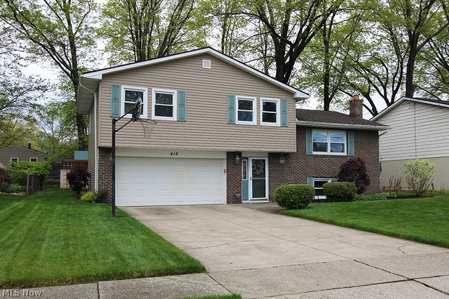 Well maintained and beautifully updated, this four-bedroom home offers a lot of living space for the price.  The kitchen is a dream with solid maple Amish-made cabinets and hardwood floor.  The lower level family room has lookout windows, a ceramic tile floor that looks like hardwood (installed in 2014), and a gorgeous brick fireplace with a hearth across one entire wall.  The lower level also contains a nice amount of storage with the laundry and an oversized window for plenty of natural light.  Updates include new roof with heat strip in 2012, all vinyl siding in 2010, furnace in 2012, air conditioning in 2014, half bath remodel in 2010, replacement of kitchen sink/faucet/microwave in 2014, fireplace door in 2011, re-painted deck in 2016, backyard paver block walkway in 2014, and glass block window in basement in 2014.