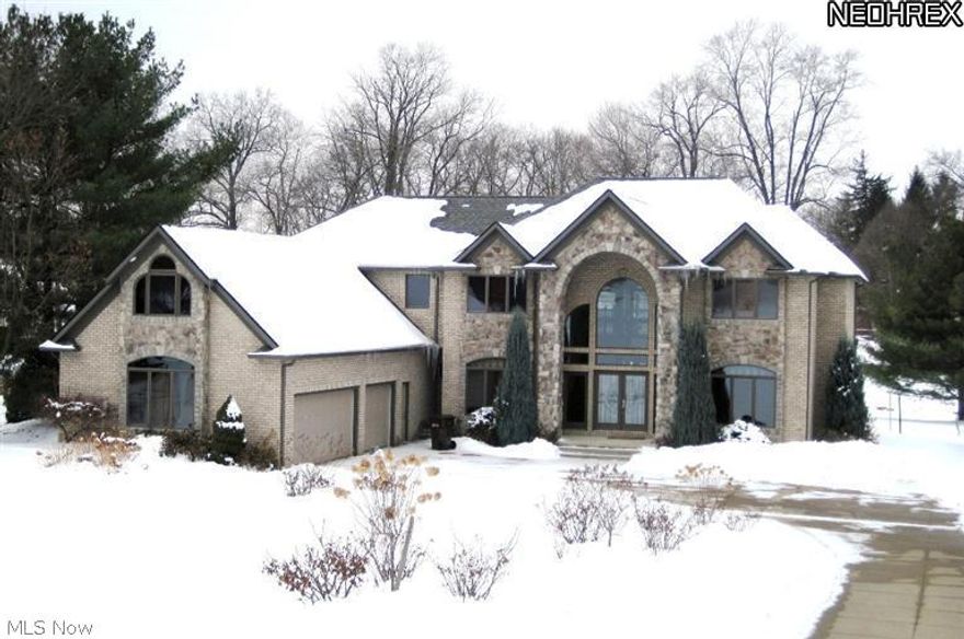 Better than new!  Outstanding all brick two level home nestled on gorgeous grounds.  Private dock.  Cul-de-sac location...serene and beautiful.  Leaded glass doors lead to spacious marble foyer with views of very open living spaces beyond. 2 story great room boasts floor to ceiling windows and stone fireplace. Adjacent bar area w/access to screened Jacuzzi porch.  3 covered balconies, off kitchen/great rm, master bdrm, and 2nd fl loft area. Custom hdwd floors thruout.  FF den w/private exterior door access.  FF bdrm and bath for guests.  Elegant 2nd floor loft to enjoy incredible views. Master bdrm w/glamour bath. 2 additional bdrms features Jack-n-Jill bath.  Large bonus room could be theater room, exercise rm, or 5th bdrm.  Other highlights include all commercial grade appliances plus 8 burner Wolf stovetop and double ovens, 15 ft. granite breakfst bar, massive walk in pantry. Front & back  staircases.  Patio w/built-in double grills.  3 c. side load heated garage. A true beauty!