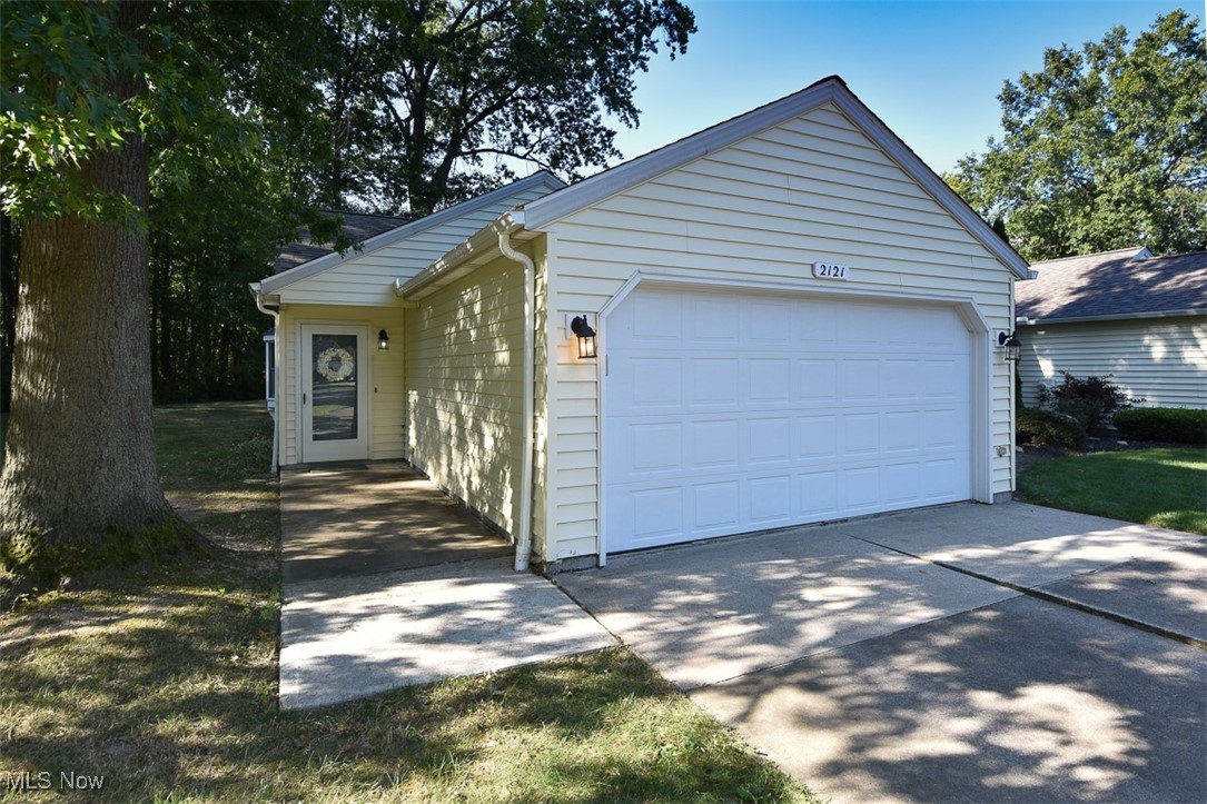 Discover the ease and comfort of this 2-bedroom, 2-full bath ranch-style condo with a spacious 2-car attached garage; an exceptional opportunity that’s hard to resist. Nestled at the end of a quiet cul-de-sac, this home offers a serene, wooded view and the convenience of single-level living. Step into the welcoming foyer with ceramic tile flooring, leading into a vaulted great room that opens seamlessly to the eat-in kitchen. Granite countertops, stainless steel appliances, and thoughtful layout make this space perfect for everyday living and entertaining. The light-filled guest bedroom features crown molding and a walk-in closet, while the primary suite offers a private en suite bath with granite vanity. The laundry room includes a utility sink and extra storage, and the pull-down attic in the garage adds even more functionality. High Efficiency furnace & newer h20 tank & AC. All appliances remain including the washer, dryer, making this truly move-in ready. Tremendous value in a prime location. Schedule your showing today!