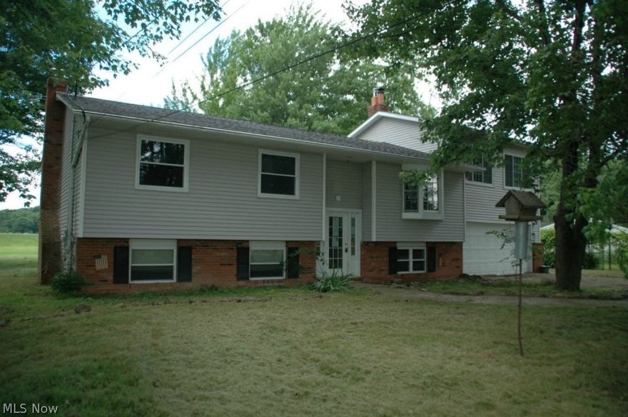 Serenity awaits you in this spacious Lake Front retreat overlooking 72 acre Lake Mont Mere in Geauga County. This home has 2380 sq ft. with 3 to 4 bedrooms and, 2 baths. This Multi-level home offers country views on 1.5 treed acres. Vaulted ceilings and skylights enlighten your living space. Large living room with wood burning stove for those chilly nights. Sliding doors lead to 4 tier deck with panoramic Lake views. This home also features a fireplace in lower level family room which also has a full bath. There is a 2 car attached garage for your convenience and an additional 32 x 24 pole barn for your toys or work shop. It is not everyday you find an affordable Lake front home to retire to. Sweat equity could leave you living the dream! Buy it today!