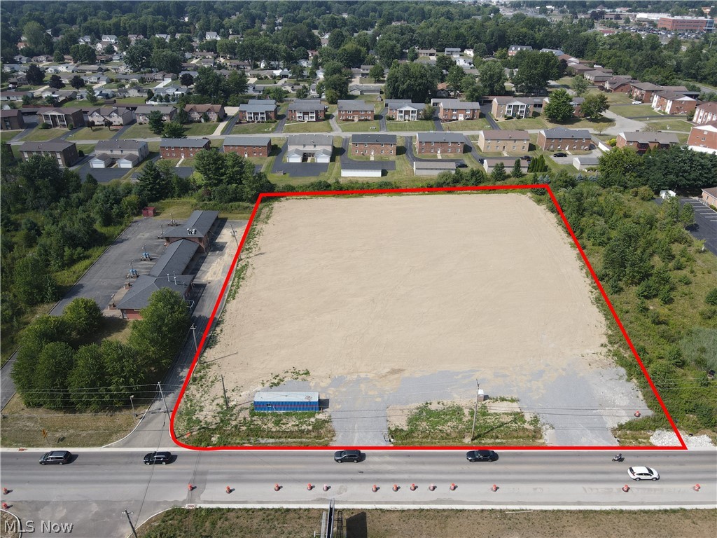 Aerial view of property and surrounding area with property parcel outlined