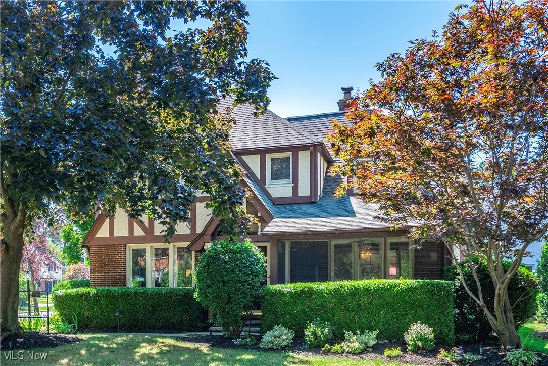 Timeless Tudor Elegance on Edgewater Drive. Built in 1925 and meticulously maintained, this pristine 5-bedroom, 4.5-bath Tudor blends classic architectural beauty with thoughtful modern updates. Original craftsmanship is showcased through rich wood moldings, leaded glass windows, gleaming refinished hardwood floors, and exquisite crystal light fixtures. A substantial 2002 addition created an expansive custom-designed kitchen with granite countertops, cherry cabinetry, a breakfast bar, and a vaulted eat-in area with skylights—seamlessly opening to the inviting family room anchored by a stunning stone wood-burning fireplace with gas starter. The first floor also features a gracious formal dining room, a refined study with French doors, a bright living room with a gas fireplace, and a powder room. The impressive west wing primary suite is a true retreat, featuring a gas fireplace, two spacious dressing rooms, and a spa-like bath with heated floors, double sinks, water closet, walk-in shower, AirBubble soaking tub, and a second fireplace—perfectly positioned for enjoying serene lake views. The second floor also offers another ensuite bedroom with dual closets, two additional spacious bedrooms, and a full hallway bath, creating comfortable accommodations for family and guests. The third floor adds even more versatility with a sun-filled bedroom, ample storage and a full bath—ideal for guests or a private retreat space. Recent upgrades enhance peace of mind, including a new roof (2025), new hot water tank (2025), new air conditioning (2023), new furnace (2022), new garage door openers, new cooktop and dishwasher, an irrigation system, and professional exterior lighting. Situated on one of Lakewood’s most desirable streets, this home enjoys a vibrant community atmosphere—often serving as a prime spot for the city’s July 4th Parade—just moments from Lakewood Park, the Solstice Steps, shops and dining of Downtown Lakewood, and the scenic Cleveland Metroparks.