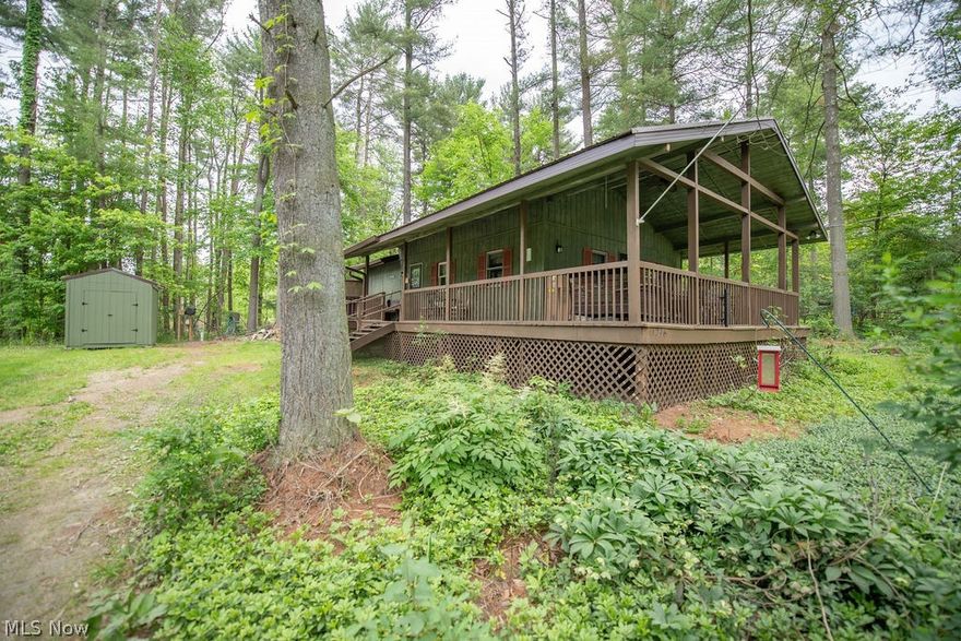 Looking for the perfect affordable getaway near Atwood Lake?   This charming 2-bedroom, 1-bath home is just steps from the lake and located in the desirable Atwood Pines community.   Inside, you’ll find an inviting open-concept layout with numerous recent updates, including a new metal roof (2019), mini-split system for supplemental heating and cooling, new shed, well pump, and more.  The home also features laundry hookups, a spacious finished loft above the kitchen for additional storage and a cozy wood-burning fireplace in the living room. The large covered front porch is perfect for relaxing or entertaining guests year-round.  Most furnishings, the hot tub, and all appliances will convey, making this property truly move-in ready.  Situated on approximately 1/3 acre with plenty of parking and a peaceful setting, this property is ideal as a weekend retreat, or full-time residence. Immediate possession available!