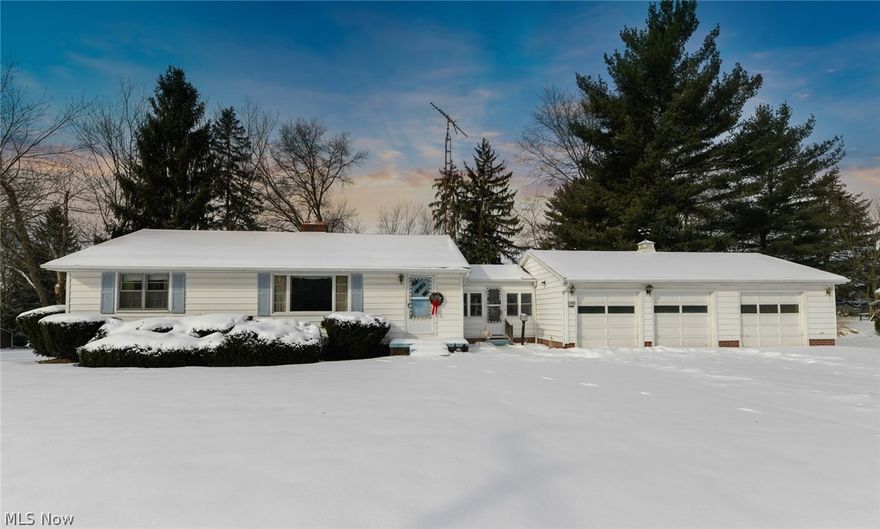 Incredible opportunity in Alliance!  This Ranch is situated on 4 whole acres!!  This classic 50's ranch offers original hardwood floors, 3 bedrooms, 2 full bathrooms and laundry on main level, attached 3 bay garage and a 4th garage on the lower level.  The breezeway gives access to the garages and the kitchen.  You will love the blast from the past when you walk in the kitchen!  The dining area is open to the large bright living room.  Off the kitchen is the enclosed sunroom with a gas heater.  You will want to spend time here enjoying the wide open view out back!  The bedrooms and main bathroom are located down the hall.  The master bedroom has an addition that is a massive full bathroom and laundry room!  Double vanity, walk- in shower and ceiling fan.  The bath/laundry room does have an extra wide door as well, to easily accommodate a wheelchair.  DO NOT MISS the basement!  There is a large central area for normal storage plus 2 bonus rooms previously used as bedrooms.  There is a w