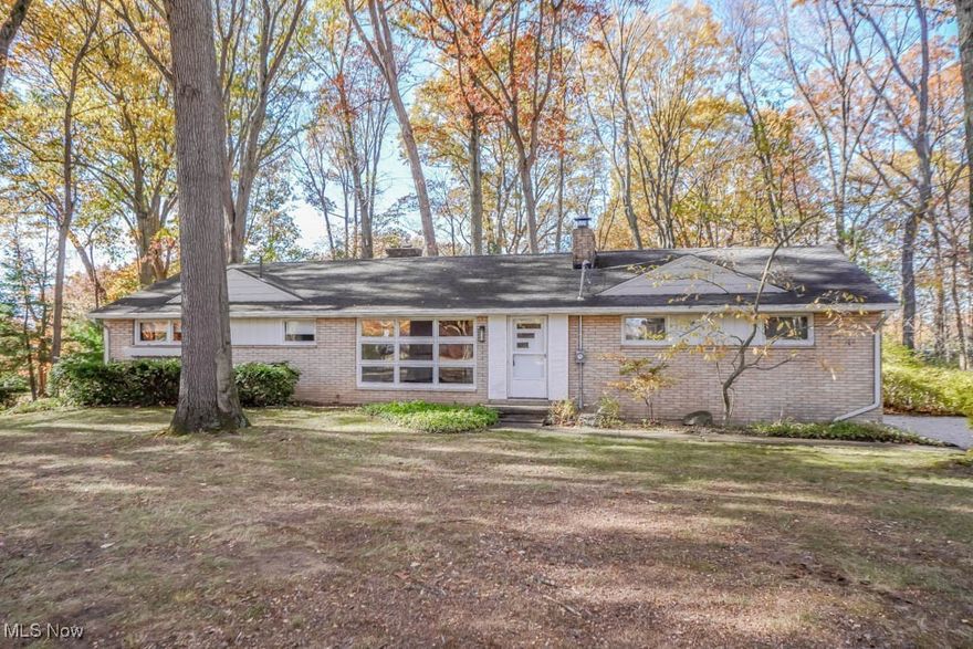 Wonderful opportunity to own an all brick ranch on nearly half an acre in Perry Local Schools! The parklike setting surrounded by mature trees makes a great first impression. Inside, the living room feels inviting with a floor to ceiling window, wood burning fireplace, and gleaming hardwood floors. The kitchen will win you over with an abundance of oak cabinetry, newer stainless appliances, and Corian countertops. French doors open to the sunroom with Andersen windows, a wood burning stove, new carpet, and direct access to the deck overlooking the wooded backyard.

All three bedrooms feature hardwood floors, and the full bath has a vintage inspired look with an extended vanity, tile walls, and a tub with shower. The lower level adds more living space with a rec room with new carpet, plus a half bath and a shower conveniently located in the laundry area, where the washer and dryer can stay. A workshop is also tucked in the basement, perfect for hobbies or crafts.

An attached two car garage, storage shed, and updates including new lighting inside and out, a partial roof, gutter guards, and outlets add to the appeal. A great find in a beautiful setting. Come see it for yourself!