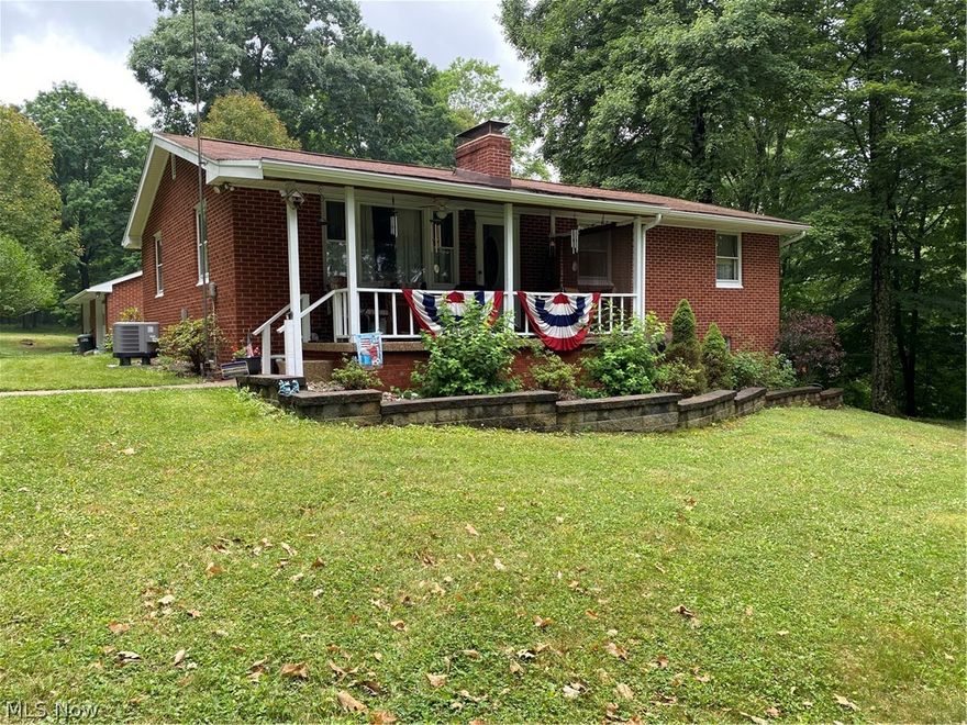 Country living at its best just outside of East Palestine.  First time on the market.  Brick ranch home boasting of just over 10 acres with woods for hunting, four wheeling or just enjoying nature.  Plenty of open area for a mini farm.  There is a 30X20 barn attached with 5 bays, oversized brick 2 car garage and a carport. Well and septic inspections for the house have been completed by the county health department.  There is an area with an additional septic and electric which was previously connected to a mobile home.  The ranch home has three bedrooms and one full bath on the main floor.  The country eat-in kitchen is fully equipped and newer laminate flooring.  Beautiful brick fireplace in the living room and newer laminate flooring.  The full basement has a second bath, family room with brick fireplace, laundry room, furnace room with wood burner and electric furnace, glass block windows and outside entrance way.  Off of the back deck is an enclosed patio  with hookups for a hot t