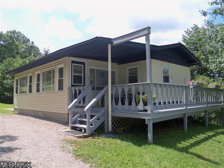 Very nice 1979 Sunnybrook mobile 14x70, sitting on 2+/- acres, in town but feels like in the country, great views, 2 Bed, 1 Bath, 6 year old roof over entire mobile with overhang(look at pictures), new vinyl windows,new front door and steps. 12x25 4 Seasons room, patio, deck, landscaped, apple trees, 1 car garage with lots of workspace, could be 2 car garage. Call office for financing details.