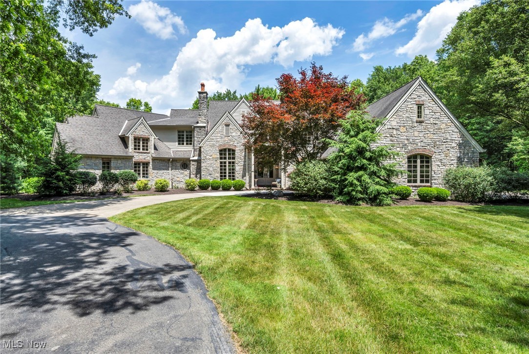 Welcome to your own private estate on 45 acres of serene wooded paradise. A long private drive leads to a grand circular driveway surrounded by impeccably landscaped grounds, a 20x50 garden bed, ½-acre pond, and apple and peach trees. A rare opportunity to own a timeless retreat where luxury meets peaceful country living. Inside, you’ll find 5 bedrooms, 7 baths, and custom finishes throughout. The gourmet kitchen features all-wood cabinetry, quartz countertops, a 2024 Wolf dual-fuel range, Sub-Zero fridge, dual Bosch dishwashers, pot filler, InstaHot, wine/beverage fridge, and spacious island. The vaulted family room with wood-beamed ceilings and stone fireplace is warm and inviting, while the two-story living room showcases a second fireplace and a wall of windows. The first-floor owner’s suite is a private retreat with a spa-inspired bath, copper soaking tub, zero-entry tiled shower, and custom walk-in closet. Elegant limestone and hardwood flooring, three fireplaces, and Pella windows and doors complete the main living spaces. Step outside to a resort-style backyard featuring a 20x40 gunite pool with motorized cover, stamped concrete, outdoor kitchen with Blaze infrared grill, granite counters, built-in cooler, and two covered patios. A massive 10,000+ sq ft heated outbuilding with 3 oversized garage doors, loft storage, ceiling fans, half bath, and car lift offers endless options for collectors, woodworkers, or business use. An additional Amish-built 10x20 powered shed sits near the pool. Other highlights: finished basement with separate living area, kitchenette, half bath, 2024 Kohler generator, invisible dog fence, new upstairs bonus room with built-in bunk beds, public water and a 3-car garage. Truly one of a kind. Please respect owners privacy-Showings by appointment only and showings will be accompanied by listing agent.