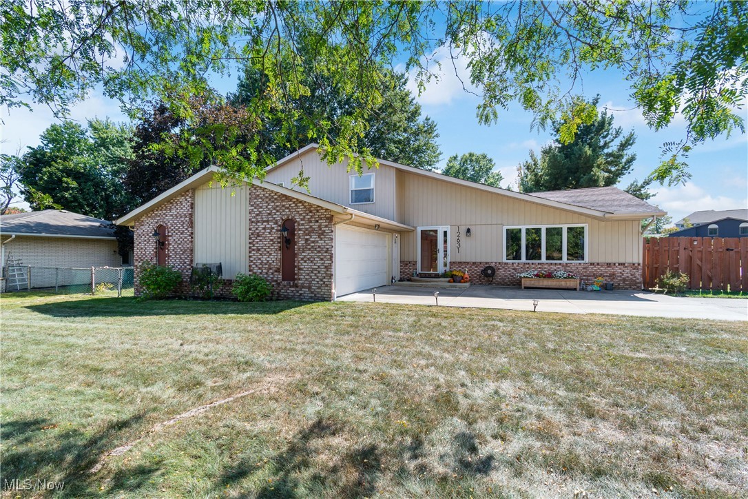 Welcome to this spacious split level located in desirable North Royalton School District. This inviting abode offers over 2,600 square feet of living space, in addition to a basement which is currently being used for storage and a workout room. There are four nicely sized bedrooms and two and a half bathrooms. Upon entry, you walk right into the living room with vaulted ceiling which opens to the formal dining room. The large eat-in kitchen offers tons of cabinet space and comes fully applianced. There is also a family room with a beautiful wood burning fireplace perfect for chilly fall evenings and there is a wet bar for entertaining. There is a first floor bedroom and half bath that round out the main level. Upstairs there are the three remaining bedrooms. The primary bedroom is oversized and has a built in vanity perfect for getting ready. There are also sliders that enter to a private deck off the primary suite. Don't forget that there is a stamped concrete patio overlooking the fenced backyard. There are also blueberry bushes and grapevines. All of this, plus a two and a half car garage. This home has been well maintained and is awaiting a new owner. Call to schedule a showing today to make this your new address!!