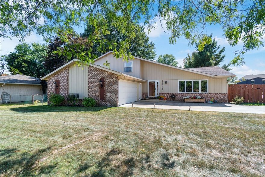 Welcome to this spacious split level located in desirable North Royalton School District.  This inviting abode offers over 2,600 square feet of living space, in addition to a basement which is currently being used for storage and a workout room.  There are four nicely sized bedrooms and two and a half bathrooms.  Upon entry, you walk right into the living room with vaulted ceiling which opens to the formal dining room.  The large eat-in kitchen offers tons of cabinet space and comes fully applianced.  There is also a family room with a beautiful wood burning fireplace perfect for chilly fall evenings and there is a wet bar for entertaining.  There is a first floor bedroom and half bath that round out the main level.  Upstairs there are the three remaining bedrooms.  The primary bedroom is oversized and has a built in vanity perfect for getting ready.  There are also sliders that enter to a private deck off the primary suite.  Don't forget that there is a stamped concrete patio overlooking the fenced backyard.  There are also blueberry bushes and grapevines.  All of this, plus a two and a half car garage.  This home has been well maintained and is awaiting a new owner.  Call to schedule a showing today to make this your new address!!