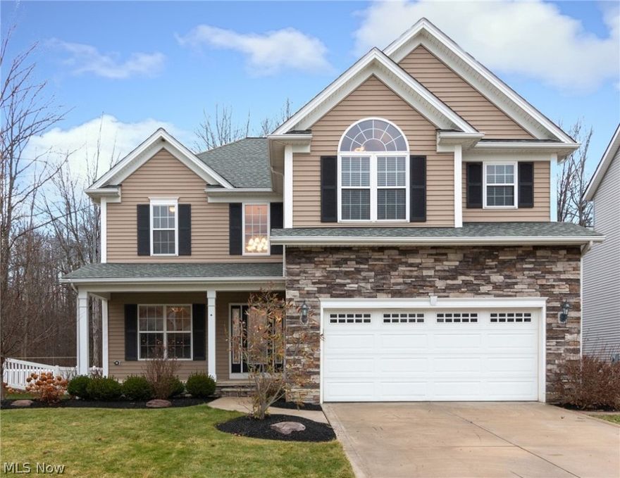 Within walking distance from Lake Erie, this beautiful contemporary colonial by Little Mountain Homes is exquisite. As one of the largest homes in the subdivision, this 5 bedroom, 2.5 bath home offers an open concept with over 2700 sq. ft. of generous living space. The eat in kitchen features a large island, stainless steel appliances and large pantry.  Relax on the beautiful stone patio with firepit and enjoy the privacy offered by the wooded nature preserve directly behind this home. The oversized great room has a striking gas fireplace. The master retreat has vaulted ceilings and cozy seating area. A large master bathroom with glass shower, spa soaking tub, and spacious walk-in closet awaits you. The unfinished, oversized basement is plumbed and ready for a fourth bathroom. Enjoy all the amenities Lake Erie Shores has to offer such as parks, playground, walking trails, pavilions, and private beach access.  Call today to see for yourself!  This home won’t last long.