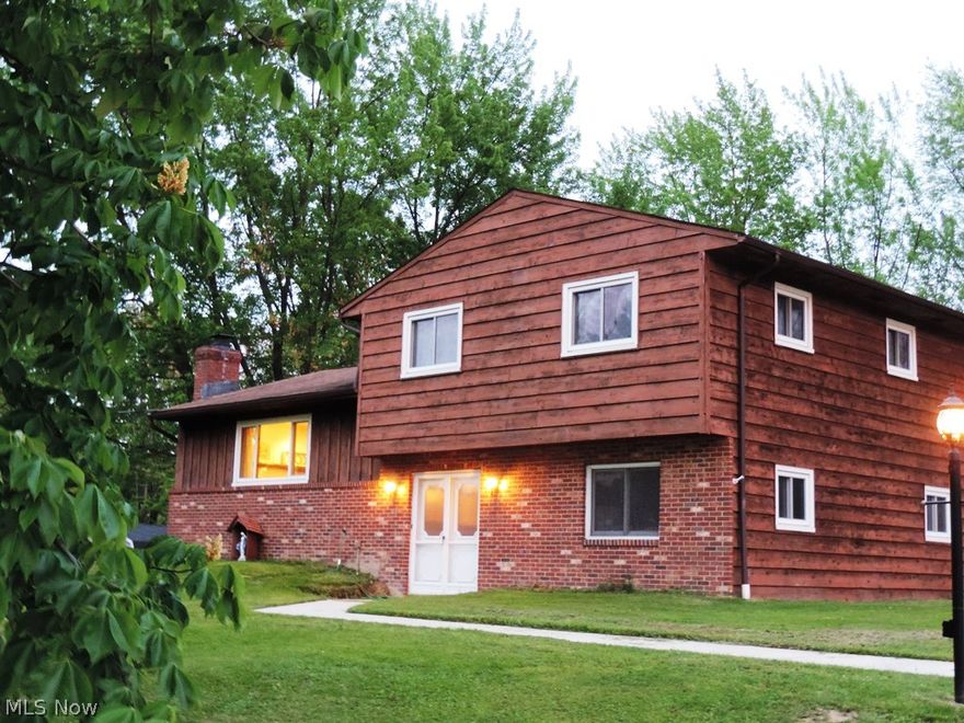 Wonderful Split Level home on over 1 Acre lot...nothing to do but move in.  Gorgeous updates include newer eat-in Kitchen with wood floors, white cabinetry, granite counters, stainless appliances and so much more.  Kitchen opens to large eat-in area with crystal chandelier and sliders that lead to an amazing patio area with built-in grill and fireplace.  Views from your patio are amazing...wooded, private and neighbors have pasture for horses!  Large Living Room with beautiful scraped wood floors and fireplace...terrific space for entertaining.  Family Room is on the entry level and opens to the foyer and has garage access, both have laminate floors.  Master Bedroom with laminate flooring has Master Bath and two other Bedrooms both with carpeting.  Beautifully updated Main Full Bath is perfect...tile floors, marble counters and newer cabinetry.  Large partial Basement has tons of room for storage or possible Rec Room area.  House is across the street from one of the holes of Shawnee Hi