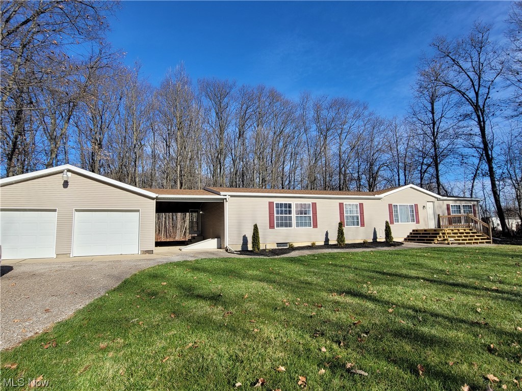 Beautiful home on serene, wooded lot! This large, manufactured home features over 1800sq ft of living space on the first floor AND a finished basement with walk out that doubles your living space! Sellers added a new front deck/porch and beautiful landscaping in 2023. This sprawling ranch style home offers a private master suite with walk in closet, jetted tub, step in shower and water closet, 2 additional bedrooms and a 2nd full bath are located on opposite end of home and in the middle, you'll love the open floor plan featuring your living room/den, formal dining room, large eat-in kitchen with plenty cabinets, drawers and countertop space. All appliances stay with home. The spacious basement offers so many possibilities! The soundproof area is great for a recording studio/movie theater vibe, pool table stays with home, large full bathroom and a formal walk out/tornado shelter type door. In addition, there is a large open room with built in wood shelving for plenty storage space, the sump pump, newer propane furnace for basement only (first floor offers it's own furnace) and an additional electric breaker panel. This great home sits on 2 parcels making your beautiful, wooded lot 1.285 acres!!! The covered breezeway between the home and garage offers additional entertaining space .... the oversized 2+ car garage offers it's own electric breaker panel, double garage doors, electric and more! Off the sliding doors from the kitchen, you are welcomed to a large deck overlooking the stunning wooded view. This home has been loved and it shows but is also in need of new flooring on the first floor. Sellers require all potential buyers must be preapproved for a mortgage loan or have proof of funds "prior" to setting up your private showing.