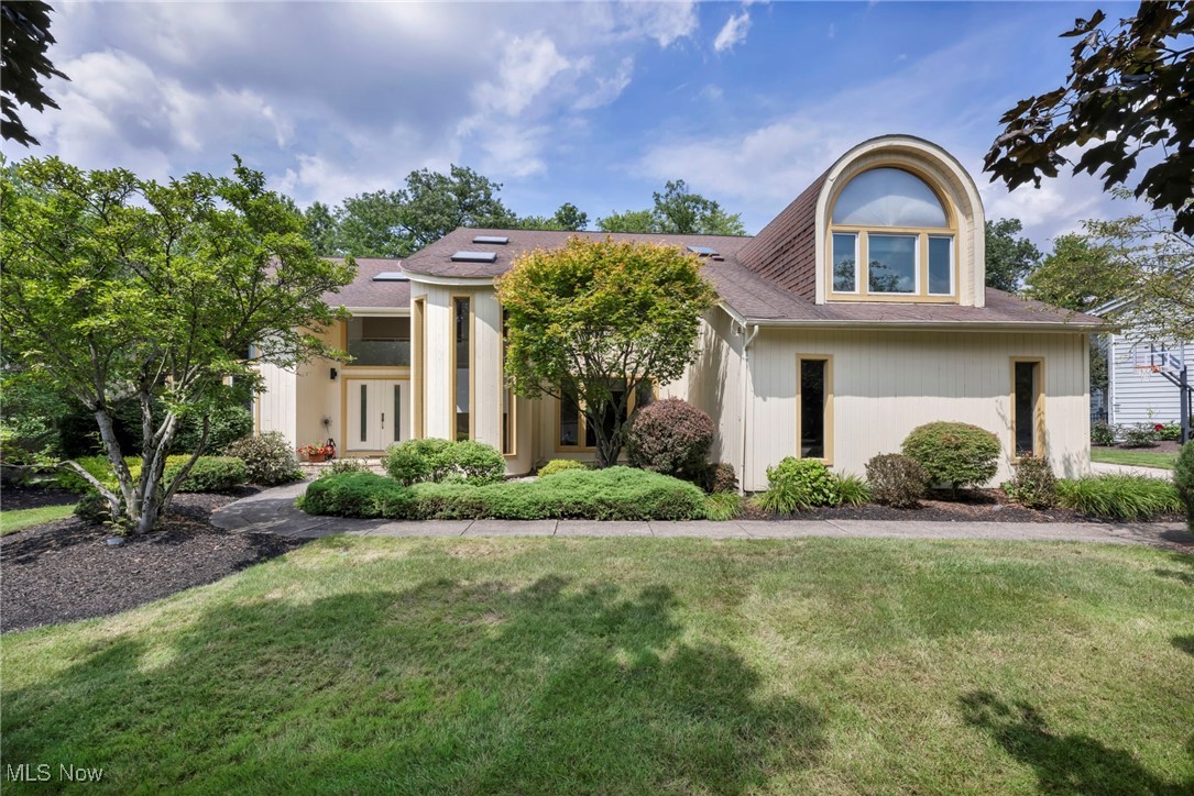 Unique opportunity to own in Orange Tree Estates, an established, close-knit cul-de-sac community within the top-rated Orange School District. Set on over .46 acres with wooded views, this spacious contemporary Colonial offers over 6,244 sq ft of living sq ft including a finished basement, and is designed for both everyday comfort and elegant entertaining. Vaulted ceilings, skylights, and dramatic architectural elements create a light-filled, welcoming atmosphere throughout. Step inside to a soaring 2-story foyer and a thoughtfully laid out first floor that includes a vaulted home office with built-ins, a formal dining room with floor-to-ceiling windows, and an updated eat-in kitchen with granite and quartz countertops, glass tile backsplash, stainless appliances, breakfast bar cooktop island, built-in desk, and hardwood floors. The kitchen opens to a striking 2-story great room with a fireplace framed in bold tilework, a wall of windows, and access to an expansive deck. The adjacent 4-season room features skylights, a vaulted ceiling, Palladian window, built-ins, and additional deck access. Upstairs, the vaulted owner’s suite is a private retreat with floor-to-ceiling windows and a spa-like en-suite bath featuring a soaking tub, double vanity, skylights, and a Roman shower with custom tilework. One guest bedroom has an en-suite bath and vaulted ceiling, while two additional bedrooms, one with a barrel-vaulted ceiling, share a Jack and Jill bath. The finished lower level includes a half bath and versatile space for recreation, hobbies, or hosting. Outside, the full-width deck provides plenty of room to relax, dine, and enjoy the natural surroundings. Additional highlights include a side-entry 3-car garage and convenient access to I-271, US-422, top shopping and dining destinations, parks, and more. INCLUDED are ALL kitchen appliances, washer/dryer, 2 TVs & mounts, speaker system, security system, window treatments & a 1-year home warranty. This home is a must see!