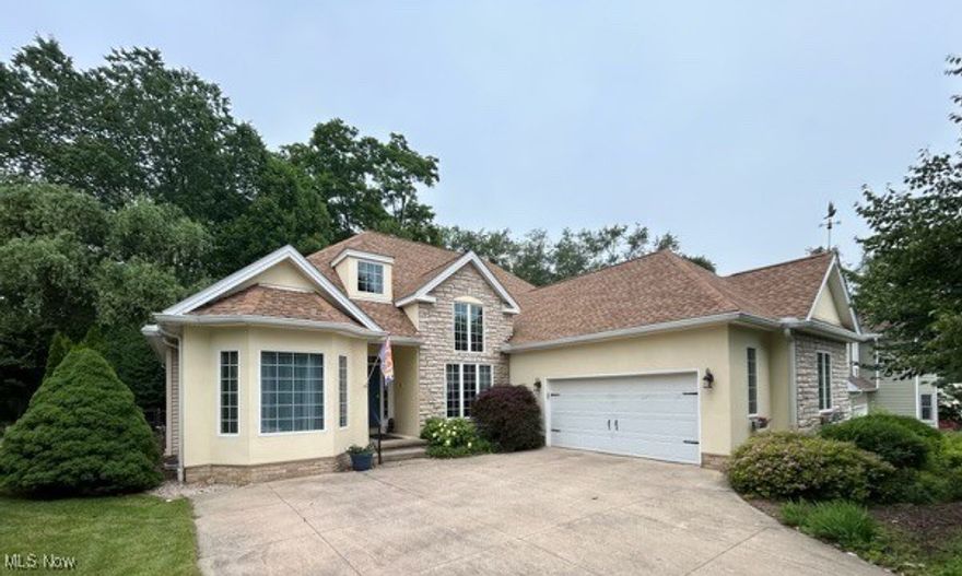 Fabulous custom built cape cod style home highlights large living spaces and unique design elements. Inviting great room features a mantled gas fireplace and 2 skylights flanked by windows. Two sets of French doors lead to the formal dining room with vaulted ceiling and hardwood floors.  Bright and open kitchen boasts center island/breakfast bar, all appliances including a wine refrigerator, planning desk, walk-in pantry and flows into the sunroom w/skylights and slider to patio, creating an ideal space for entertaining and relaxing.  Large first floor owners suite presents tray ceiling, bayed sitting area, wall of closets, large WIC, and private bath with h/h vanity.  The second bedroom is spacious and offers access to a full bath.  Located on the first floor is the laundry room with gas hookup for dryer, utility sink, and cabinetry.  The second floor bonus room includes a private full bath and an L-shaped storage closet, offering excellent potential to be converted into a third bedroom.  An additional 1531 sq ft in the lower level features multi-purpose/flex space, workshop, the addition of half bath, and much more.  Intimate outdoor patio overlooks a wooded backdrop with gardens and offers a peaceful and private retreat.  Just minutes from Stan Hywet and Cuyahoga National Parks, this beauty is nestled on a dead end street in a quiet neighborhood.  Notable updates include roof '22, furnace /AC '15, hot water tank '13, central vacuum, addition of drop ceiling/soundproof. Close proximity to downtown Akron, towpath, hospitals, and cultural opportunities.