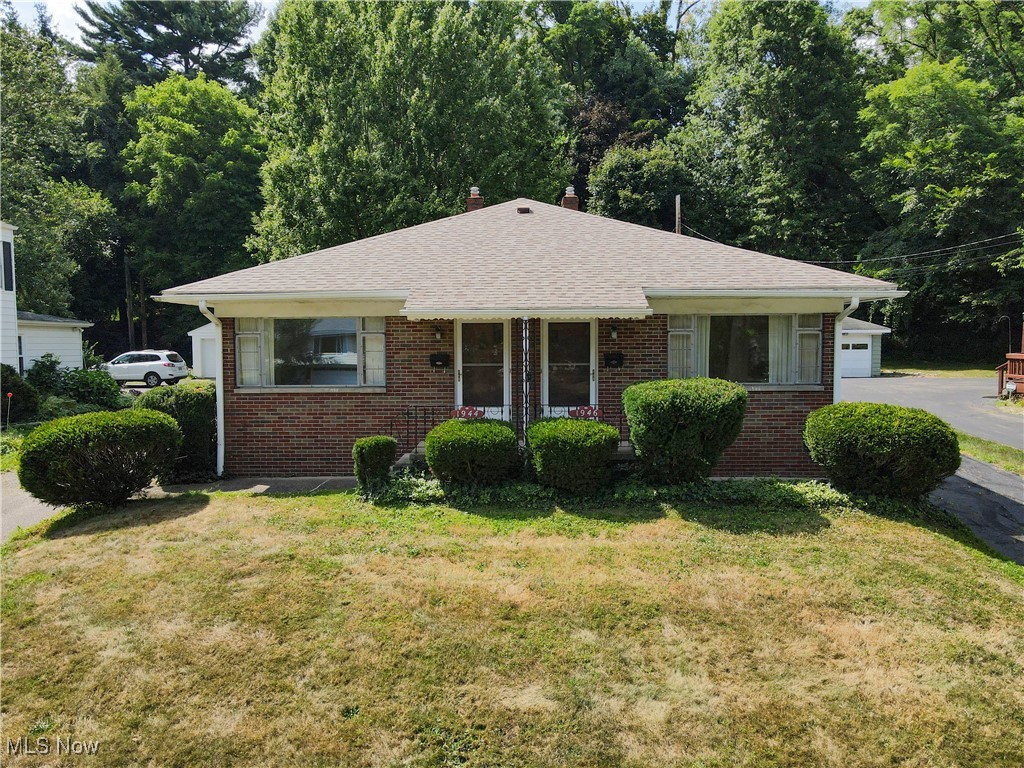 Ranch-style, brick duplex in a PRIME Cuyahoga Falls location! Retro 1950s charm, impeccably clean and well-kept. Hardwood flooring throughout living, dining and bedrooms. Each unit offers its own PRIVATE full basement for storage. Detached 2-car garage with partition, allowing each side to have its own parking space + additional parking behind the building. A patio surrounded by mature trees creates a backyard oasis perfect for relaxing or entertaining. ALL utilities for each unit are metered separately! Live in one side and rent out the other or lease both and make this an absolutely fabulous investment opportunity! Roof (on home + garage) approx. 10yo. Ask your fav Realtor for other known updates.