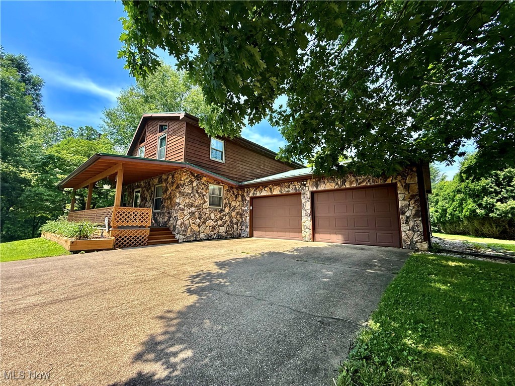 Tucked away just past Butchers Farm, 19 Brettwood is a hidden gem on nearly an acre in a quiet development. Mature trees surround the corner lot, offering privacy and peaceful views from multiple decks and an over-sized screened porch. A swing overlooking a charming fish pond invites you to unwind and enjoy all the sights of nature. Inside, a beautiful stone fireplace climbs to vaulted ceilings, anchoring the spacious open layout and showcasing the loft area. The home features 3 bedrooms and 2 full baths, including a convenient first-floor bed and bath. The full-height, walk-out basement is ready to finish, offering endless possibilities. With an attached 2-stall garage in front, a rear 1-stall garage, a large outbuilding, and plenty of space for an RV or boat, this property blends comfort, character, and potential. Cozy, private, and full of charm—19 Brettwood is ready to welcome you home.