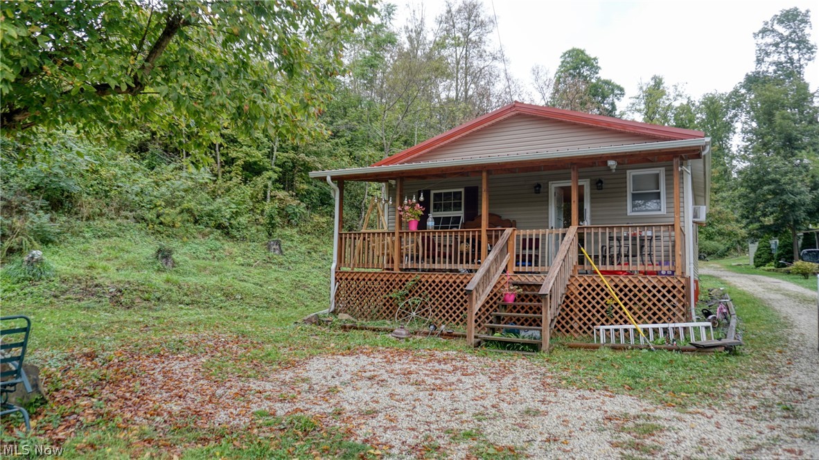 14 acres with small ranch-large covered front porch. Mini farm w/ 2 homes. 2 BR, 1 BA, gas heat plus 1978 2 BR trailer w/ spring and chicken coop, several out buildings, 2 small ponds, 2 separate septic.