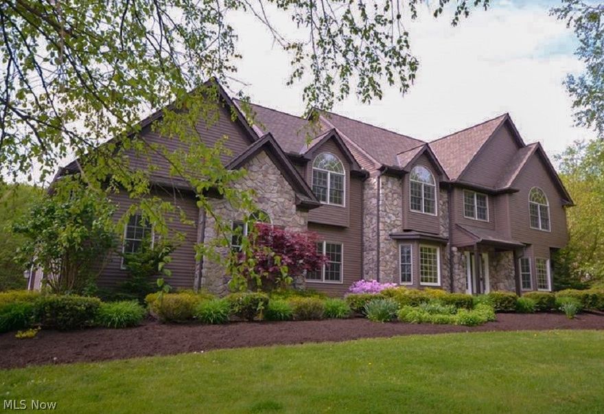 Hidden from the road you will love this stunning colonial w/stone facade on over 6 acres! Beautiful trees, fruit trees, blueberry bushes & serene landscape. Enter & notice the beautiful wood staircase & character of the detailed wood trim throughout. Oversized windows allow plenty of natural light in dining rm w/transom doorways, bay window, tray ceiling & chair rail.  Living rm & family rm connect w/dbl doors for a versatile layout. Spacious eat-in kitchen w/granite counters & island, plentiful cabinets w/lighting, desk area, walk-in pantry & SS appliances that stay. Kitchen opens to spacious family rm w/stone FP & ornate wood mantle. Continue entertaining & relaxing through sliding doors leading to the large wood deck & treed yard. Spacious office w/functional built-ins, half bath & spacious laundry rm all on 1st flr. 2nd level opens into a sunny loft area- then a HUGE master bdrm retreat w/large walk-in closet & cedar closet, beautiful ensuite w/luxurious tub & separate shower. A LG