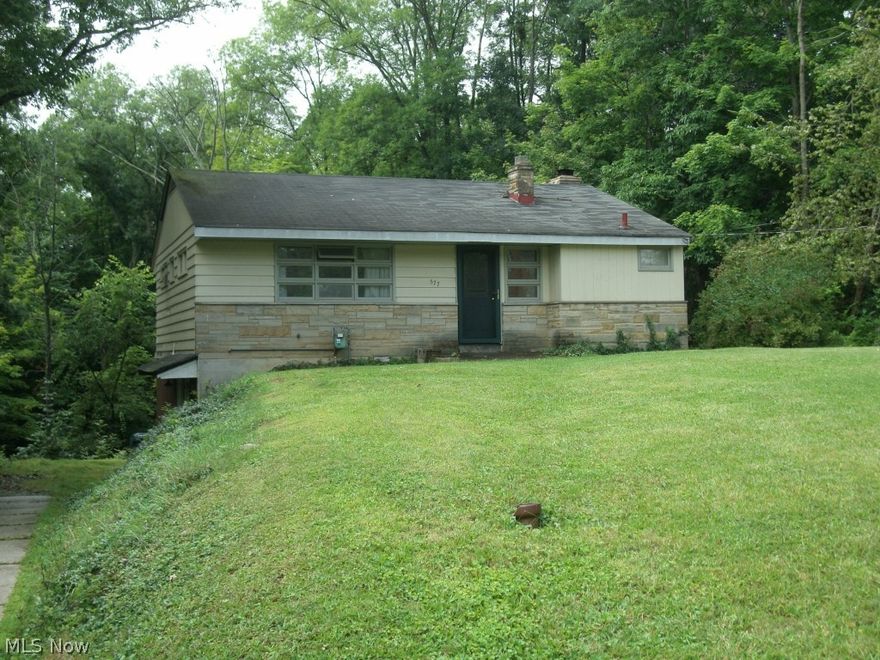 Ranch with walk-out lower level sloping. Private wooded views House needs work plus updating but could be spectacular. Wooded setting for the nature lover that slopes down away from house to creek. Kitchen, dining and living room located in lower level.