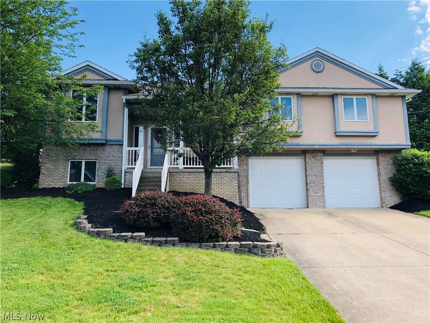 A home to fit your lifestyle that's nicely updated with neutral colors, white trim, wood floors.  Just beautiful!  Walk in to a large open foyer to the living room with gas fireplace, tray ceiling, built in bookcase.  Eat-in kitchen with lots of counter top & cabinets with recessed lights, backsplash and stainless appliances that stay.  Walk out to a fenced yard with nice brick retaining wall and large patio with room for outdoor entertaining.  Beautifully landscaped.  Covered porch.  1st floor laundry convenient by bedrooms.  Large master bedroom with tray ceilings, wood floors & perfect bath, double sink, walk-in closet, jetted tub, shower, skylight.  Two other bedrooms are spacious & neutral.  You'll love the lower level with half bath, rec room & exercise or play area with recessed lighting, nicely carpeted.  Location is desirable with lots of trees, front & back for shade & privacy.  Street is a cul-de-sac.  2 car garage.  Don't miss out!  Home Warranty.