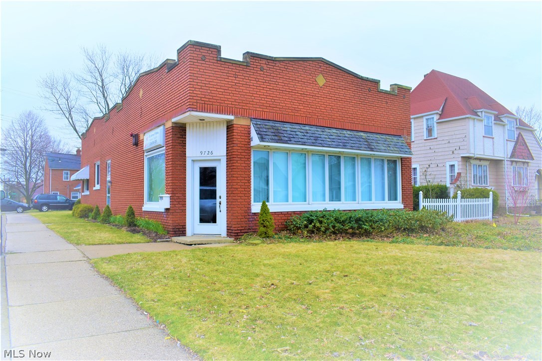 Charming well maintained all brick building located on a busy corner just minutes from I 480. Commercial store front is 784 sqft most recently used as a dentist office. Back unit is a 2 bedroom 1 bath turn key apartment unit with many updates rent ready! Partial basement under the apartment is partially finished which adds another 812 sqft below grade. Also included is a 20 X 28 extra large 2 car garage built in the 1990's. A must see! Many possible uses.