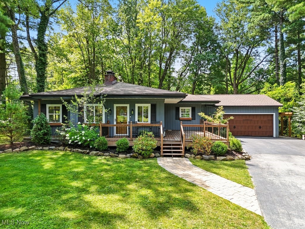 Welcome home to this EXCEPTIONALLY renovated 3 bedroom 3 bath home tucked away on a quiet street, yet minutes from downtown Chagrin Falls. The functional flood plan offers open concept living, top to bottom updates, and loads of natural light. Enjoy the updated chefs kitchen featuring quartz countertops, Carrara marble backsplash, SS appliances, walk-in pantry, and an island with seating. The generously sized living room is equip with a cozy fireplace, wall of windows, and walk-out doors. The one-of-a-kind primary suite is sure to impress with upscale design elements, a well thought out walk-in closet, and luxurious glamour bath featuring a soaking tub overlooking the private back yard, dual sink vanity, and oversized walk-in shower. Two additional bedrooms and another updated full bath are located on the first floor. Downstairs you will find over 1,000 square feet of additional living space including a comfortable fireplace, full bathroom, wall of built in hidden storage, the well designed laundry room, and lots of storage space. The outside space speaks for itself and offers total relaxation, privacy, and a fully fenced in yard! Enjoy the beautiful mature landscaping and lush greenery from the newly built decks on both the front and back of the home. Every detail of this home was well thought out and designed....from light fixtures, to flooring, to the intricate millwork...just to name a few! Call today for more details and to schedule your private tour of this AMAZING Chagrin Falls home!