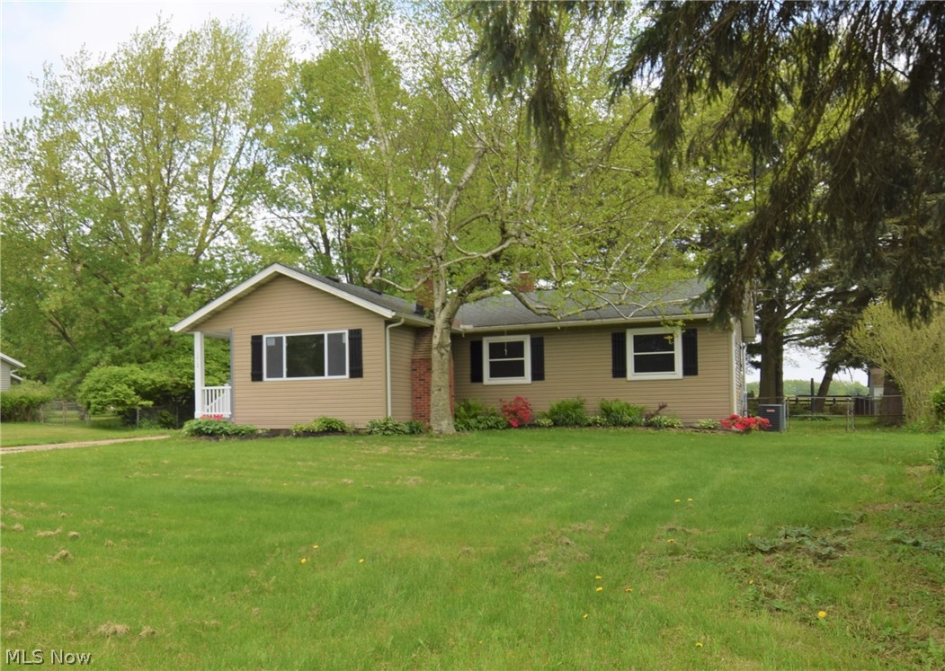 Welcome to 1212 Martin Road in Mogadore! This four bedroom, two bath ranch has been completely remodeled; the stunning updates are sure to take your breath away. You’ll find beautiful original hardwood floors throughout most of the home, including the living room, dining room, hallway, and bedrooms. The kitchen and bonus room have new gorgeous premium flooring. The kitchen also has brand new white cabinets, new stainless steel appliances, a stylish backsplash, and recessed lighting. Right off the kitchen is the spacious bonus room, which has a breakfast bar, French doors leading outside, and a modern electric fireplace. The basement has a fireplace, new tile flooring, completely renovated bathroom, a bar, and a spacious room. Outside there is a two-car detached garage, a concrete patio, and beautiful landscaping. This home is gorgeous and won’t last on the market long – schedule your showing NOW!