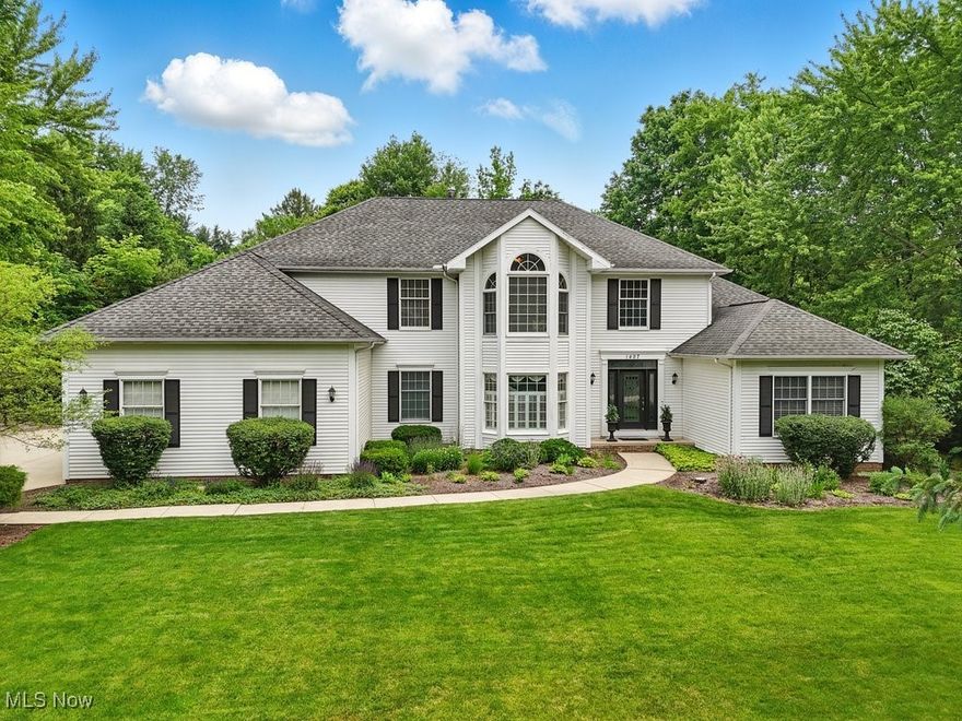 Welcome to your dream home in the sought-after Hunt Club community of Hudson! Nestled on a serene 1.85-acre lot, this stunning property offers the perfect balance of comfort, luxury, and privacy.

Step inside to discover a thoughtfully designed interior, where an open-concept layout and sun-drenched living spaces create an inviting atmosphere. The expansive kitchen is ideal for entertaining, featuring ample counter space and a seamless flow into the light-filled living area.

The luxurious first-floor master suite is a peaceful retreat, complete with a sliding door that opens to a spacious deck—perfect for enjoying your morning coffee while taking in views of the private, wooded backyard.

Upstairs, you'll find three generously sized bedrooms, each with walk-in closets, along with two full baths. A cozy additional room provides the ideal space for reading, studying, or a home office.

The full basement offers endless possibilities, whether you envision a home theater, game room, gym, or guest suite.

Don't miss your chance to own this exceptional property—schedule your private showing today and experience the perfect blend of tranquility and modern living!