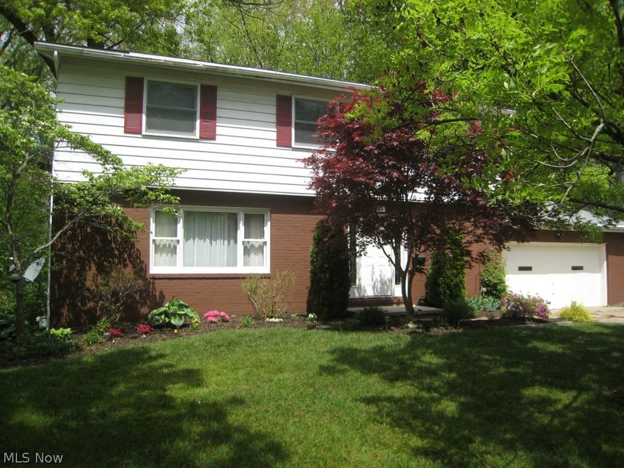 This is a rare 5 bedroom home so reasonably priced. It also over looks a wooded ravine with a beautiful view. There are many areas to relax in this home. The living room has hard wood floors and opens to the formal dining room. The kitchen flows into the family room. The family room has a cozy wood burning fireplace to keep you warm. The sliding door off of the kitchen leads to a covered deck and the back yard. The back yard is fenced with a fire pit perfect for cook outs. The second level has 5 bedrooms with an updated master bath. Plenty of room for an office too. The basement is finished with a rec room and a separate workshop area. The basement has been professionally waterproofed and is under warranty. The central air has been updated. This is a very lovely home.