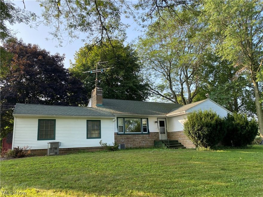 Beautiful and private ranch home nestled on 1.5 acres with a waterfront view! It's everything you've been looking for. The remodeled kitchen features new cabinets, stunning countertops, gorgeous backsplash, and stainless steel appliances. A breakfast bar opens to a dining area. Spectacular views of the water can be seen from the large picture window in the living room and a window in the master bedroom. The living room also features a lovely stone fireplace with new wood burner. Three ample sized bedrooms and a full bathroom complete the main floor. The basement is another 1200 square feet and includes a large rec room, storage room with shelves, a workshop, and a space to do laundry. Washer and dryer are included. A walk-out basement leads from the workshop to the screened in porch. Improvements & other amenities include new septic (2020), electrical box (2019), water softener (approx. 3 years old), 20x26 detached garage, whole house generator, & plenty of fruit trees. A real treat!