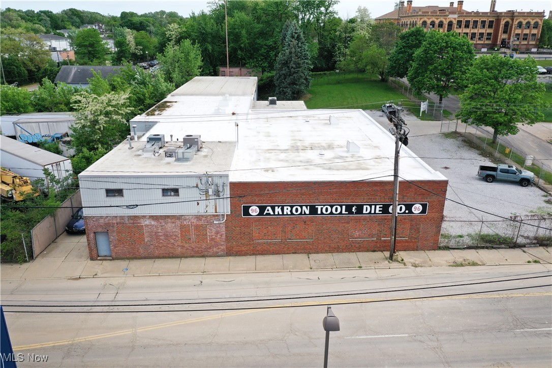 Located in downtown Akron on a corner lot. 21,000 sq. ft. industrial warehouse that is currently the global headquarters for a large Industrial Equipment Manufacturer. Very clean! Building features both up and downstairs offices and conference room. Most industrial cranes will stay. New roof and new insulation, (2022). New natural gas heaters installed in the warehouse in (2022). Office space has HVAC heating and cooling. Three restrooms on site. Large, gated parking lot with security system. Extra space for parking expansion. Drive in door for easy delivery in and out.