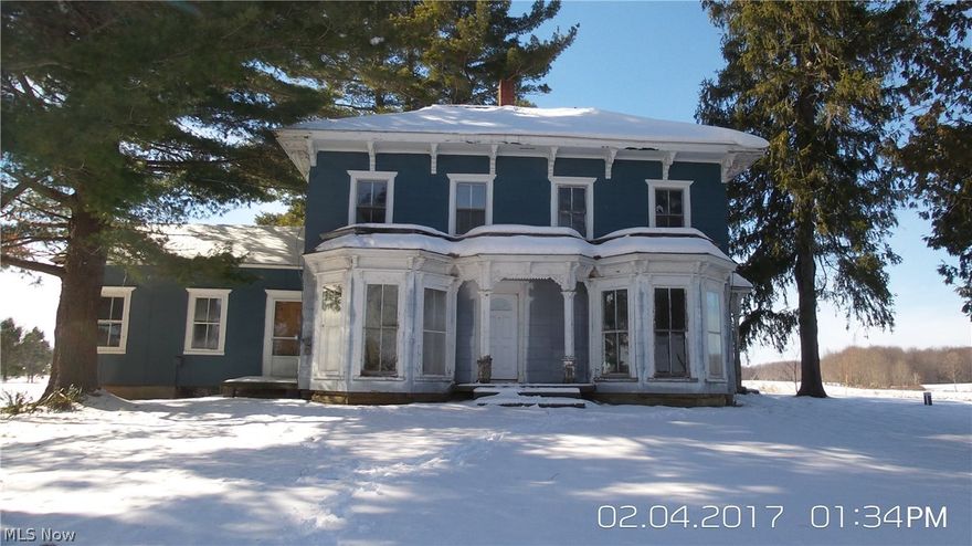 Large home located on over two acres.  Three bedrooms and a large full bath upstairs.  Spacious downstairs with beautiful front windows.  Property is in need of repairs and renovations, but could make a beautiful home if restored.