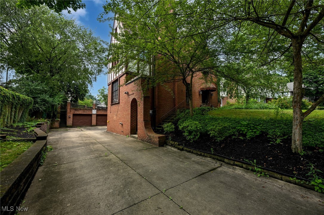 Magnificent brick Tudor in historic Ridgewood offering over 4100 square feet plus additional living space in the finished walk-out lower level. This spectacular property features 6 bedrooms, 4.5 baths, and a 3 car garage. Built in 1926, this stately home was designed for the Mann family, one of the largest retailers in Canton. A truly remarkable example of superior craftsmanship and attention to detail that has stood the test of time. Stunning 24 x 17 sunken living room with full wall wood paneled fireplace, gorgeous crown moldings, window seat, and hardwood floors. Enjoy dinners with family and friends in the large formal dining room. Library/office with custom paneling, beams, built-in bookshelves, and fireplace. The chef's kitchen features 2 sinks, a gas Viking range, loads of cabinets, and overlooks the 2 outdoor patio areas & beautiful backyard. Natural light surrounds you in the inviting family room with windows on every wall and a custom cupola. Family room has an additional fireplace and walks out to the rear covered patio. Unbelievable 22 x 15 master-bedroom with large closet, built-ins, and beautiful fireplace. 3 bedrooms and 2 baths complete the second floor. The third floor offers 2 additional bedrooms, an incredible bath with soaking tub and double sinks as well as a huge walk-in closet. You will be awed with the perfect blend of historical charm and modern updates in this extraordinary home. Enjoy a community focused on preserving the richness of the past while embracing the dreams of tomorrow.