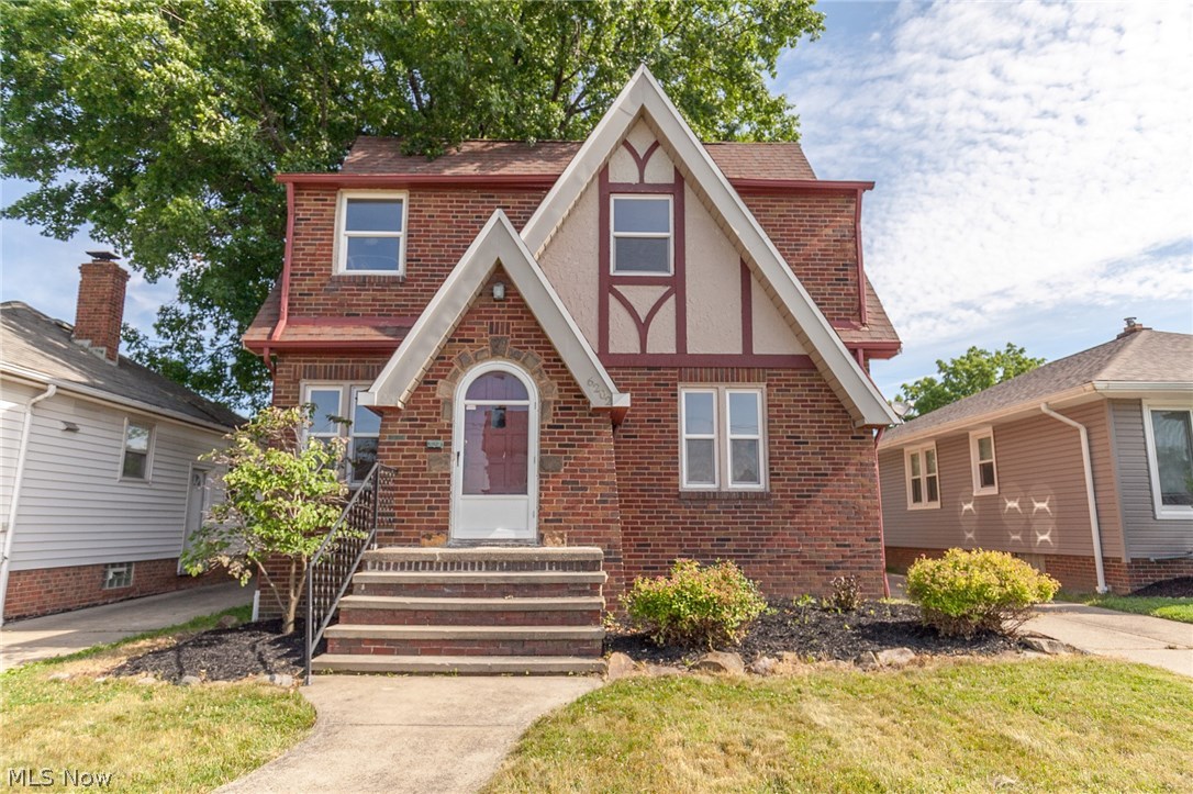 Charming brick, Tudor-style, Colonial on a quiet street. With rich wood flooring through-out, arched doorways, and original details this home is warm and welcoming. Enter into the large living room from the front door and be greeted by the natural light and decorative stone fireplace. Imagine cozying up in the living room with a movie on after a long day. The living room is partially open to the formal dining room, providing sight-lines yet distinct spaces. The dining room has quaint built-ins and plenty of space to accommodate a large table for all your family and friends. The kitchen has a fun back-splash and a cozy breakfast nook for enjoying meals or your morning coffee. The second story has three spacious bedrooms and is completed with a full bath. A fun added touch to the owner's suite is the balcony overlooking the back-yard. The basement is just waiting for your personal touches to transform it into an awesome media room or additional living space and has optimal storage space.