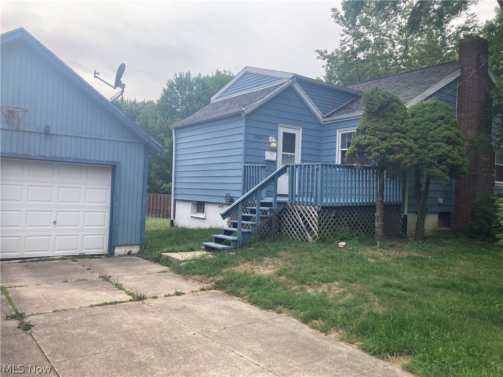 WHY PAY RENT? Own this beautiful Stow property for less. Situated on a corner lot just under 1/2 acre in a quiet
area. Property is zoned E-2 with the possibility of splitting the parcel and building an additional home! Enjoy the conveniences of one floor living! This home has a first-floor laundry room, no more carrying baskets up and down stairs! The oversized (1.5) car garage is equipped with a floor drain and plumbed for all of your work/hobby needs! The full basement is a walk out for added convenience. The bright and sunny eat in kitchen is enhanced with beautiful, solid wood, Merillat cabinets and a SS double sink. Step out of the living room onto a large deck and enjoy the peaceful and private surroundings overlooking a wooded area and fire pit! Great for entertaining, morning coffee or relaxing after a long day. Auditors' website has this property as a "2 bedroom", although there is not a closet in the smaller room. The roof and water tank appear to be 5-10 years old and windows are newer vinyl. Endless possibilities are offered here at 3723 Baumberger Rd. make your dream of homeownership a reality before this gem is SOLD!!!