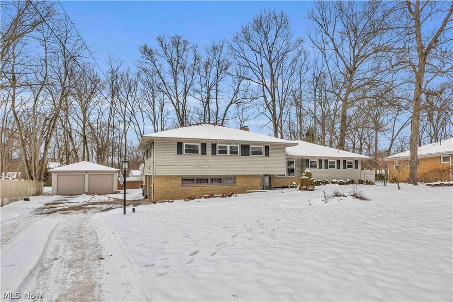 Welcome home to 6624 Ronjoy Place, a spacious, character-filled tri-level built in 1959. From the moment you enter, you’re greeted by an expansive family room showcasing a striking blend of plush carpeting and elegant black marble flooring, while a wall of picture windows overlooks the large backyard and fills the space with natural light. Up the wide, formal staircase, the main level features a generous eat-in kitchen with black marble accents, abundant counter space, ample cabinetry, and a cozy breakfast nook, along with an adjacent dining room surrounded by oversized windows that create a bright, welcoming setting with beautiful backyard views. The living room is truly grand, highlighted by soaring ceilings with frieze-style plaster detailing and crown molding, oversized windows, and a stunning stone hearth with a wood burning fireplace, perfect for entertaining or relaxing evenings at home. Upstairs, you’ll find four spacious bedrooms offering flexibility for family, guests, or a home office, while the fully waterproofed basement provides excellent storage and future finishing potential. Car enthusiasts and hobbyists will appreciate the four garage spaces, including two attached garages and a sizable detached garage with high doors ideal for large vehicles, a workshop, or additional storage. Located just minutes from Mill Creek Park and convenient to shopping, dining, and entertainment, this home offers space, character, and opportunity, and with a few finishing touches, it has the potential to truly shine. Schedule your private showing today.
