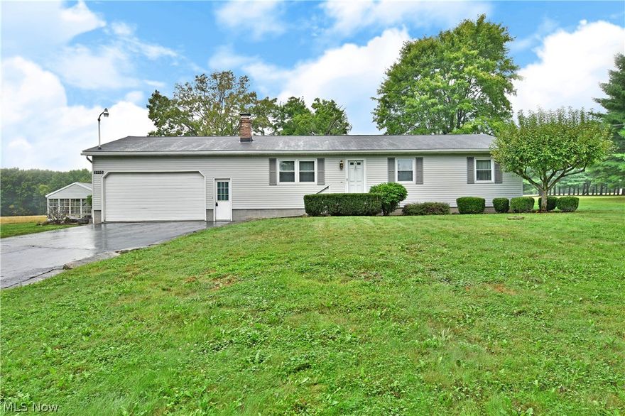 Don’t miss your chance at this impressive Hartford ranch home, ready to delight with its scenic surroundings and unique included greenhouse! The semi-rural setting quickly puts you at ease as you make your way up the blacktop drive to find the handsome residence, showcasing it’s clean gray siding in sculpted landscaping. Step inside to find the spacious living room awash in natural light while a brick trimmed fireplace commands attention at the far wall. The ample kitchen is found through the next doorway, providing casual, eat-in dining along with its array of stained wood cabinets. Nearby, the finished rear sunroom allows for easy four-season relaxation as it ties to the rear patio. Down the main hall, a sizeable full bath features an updated bath as it joins the trio of carpeted bedrooms. The larger master is complete with its own private half bath. Down below, a full basement brings plenty of rec space along with a pair of bonus rooms and potential bar area. Additional workshop spa