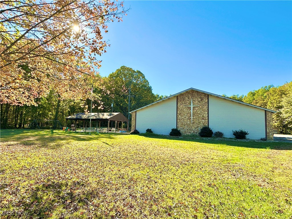 Outstanding opportunity for investors, developers, or institutional users. This expansive property,currently used as a church, is situated on 5.74 park-like acres with mature landscaping, open green space, a playground, and covered shelter. Built in 1983 and well-maintained, the nearly 10,000 sq ft building is ideal for a wide range of commercial or community-based uses such as a school, daycare, event center, worship facility, or nonprofit headquarters.
The layout includes a full-size gymnasium, large sanctuary/auditorium, multiple private offices, classrooms, nursery, community/multi-purpose room & kitchen. Infrastructure highlights include 3 furnaces (one replaced in 2023), new smart thermostats, updated water heater, newer refrigerator and  restrooms with new toilets.
Oversized parking area and open land provide room for future expansion or redevelopment. Buyer to verify zoning use. Flexible use potential - ready for it's next chapter.