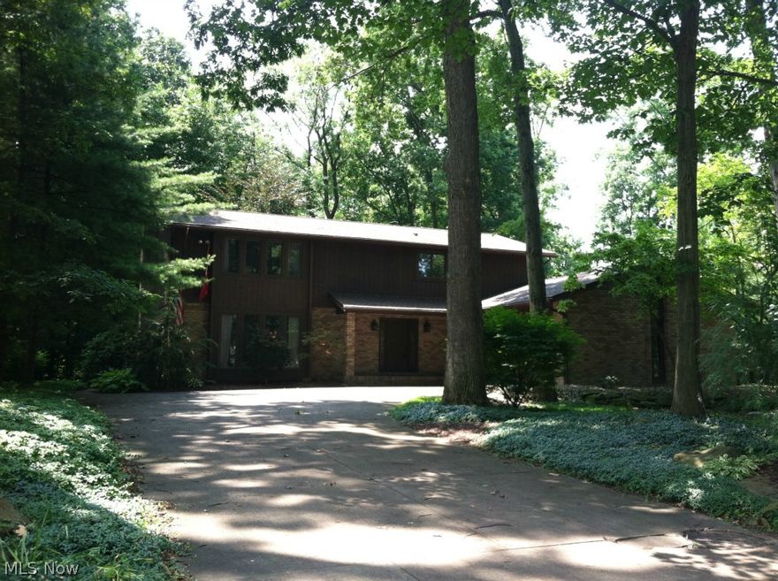 This 4 bedroom, 3.5 bath residence sits on an amazing wooded lot and features views of the ravine and stream that run alongside it.  It is the perfect setting for this 2888 square foot two-story home that boasts spacious rooms, huge windows, brick fireplace, sunroom, lots of closet space, partially finished basement, multi-level deck, patio and a courtyard.  Updates include roof (2012), HVAC (2010) and electrical service (2012).  This home has so much to offer - location, space, quality, privacy and, of course, the view!