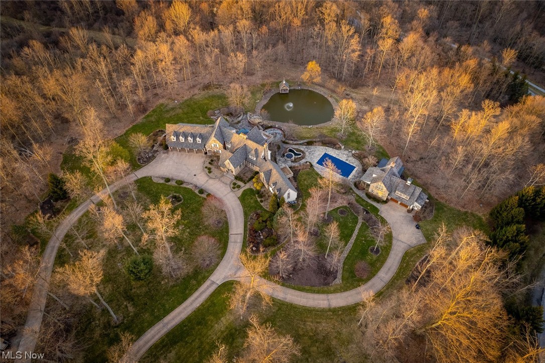 Extraordinary home with every luxury and amenity imaginable. The expansive five-bedroom home offers many views of the serene pond and property. Privately situated on over 7 acres of flawless grounds. This home was constructed with no expense spared! Sprawling entertainment spaces inside and out. A Chef's dream kitchen that features the finest LaCornue range. Luxurious first floor owner's suite, second floor in-law suite with elevator access to all floors. Walk-out lower level offers an exercise room, family room, game room, full bar and wine cellar, and more. Ultimate backyard getaway with pond, inground pool, spa, gazebo, patios, and a guesthouse with everything including a relaxing sleeping porch- WOW! It’s magnificent!