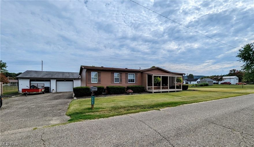 Roomy manufactured ranch home sitting on a large 1/2 acre lot. Home offers 3 bedrooms, 2 full baths, full partially finished 13 block basement and a detached 2 car garage. The home does need updates and finishing touches inside. Many repairs were completed prior to listing. Call for more details. Selling "As Is"