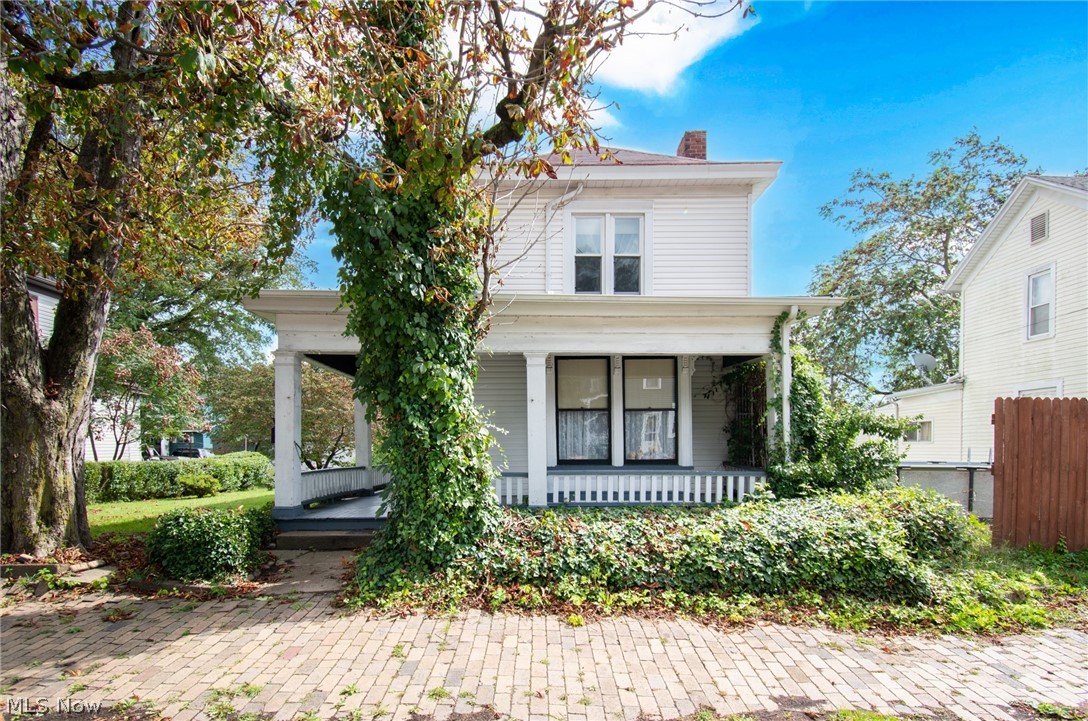 Welcome to this charming 4 bedroom home located within walking distance from Wellsville's football stadium. This home was built in 1890, and is full of character and so much light. Whether buying to flip, occupy or rent out this home has so much potential. Exterior features you'll find in this home include a large wrap around front porch waiting to be decorated for fall, a large back deck, partially fenced in yard with a shed, and 2 garages located on the additional 2 lots included with the property. When you walk into the home you will find a large formal dining room with a beautifully crafted fireplace, a spacious living room featuring another beautiful fireplace and the perfect little window seating area. The eat-in kitchen features handcrafted orginal built-in cabinets with a large amount of storage available. Off from the kitchen is the main bathroom that features a claw foot tub. Upstairs features 4 bedrooms with hardwood floors throughout and a half bath.