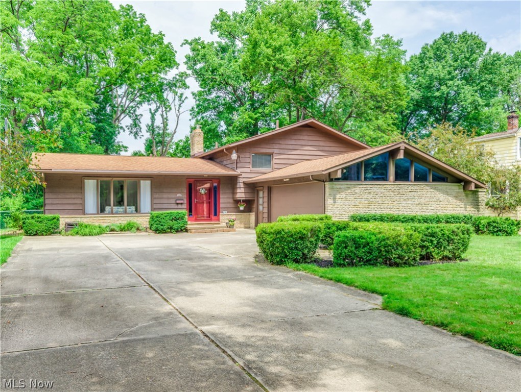 Custom Built 4 level split with cedar and sandstone exterior. Situated in Silver Lake Estates where lake privileges are included. Conveniently located within walking distance to elementary and middle schools or to Silver Lake and Crystal Lake. Step into the foyer entry to access the bright and open formal living and formal dining with soaring beamed cathedral ceiling. Nicely updated kitchen is open to the dining room. It has beautiful hickory cabinets with pull out shelving, black granite counters, touchless faucet, canned lighting and a slider stepping out to the 27 x 18 deck porch overlooking the private backyard. Going up a few steps you'll find 4 bedrooms, 2 full baths and a whole house attic fan. In the lower level is a cozy family room with wood beamed ceilings, rich walnut stained paneled walls and a sandstone wood burning fireplace. There's also a fifth bedroom, full bath, access to the garage and sliders to the 24 x 10 glass enclosed cedar sun room. A few more steps down to th