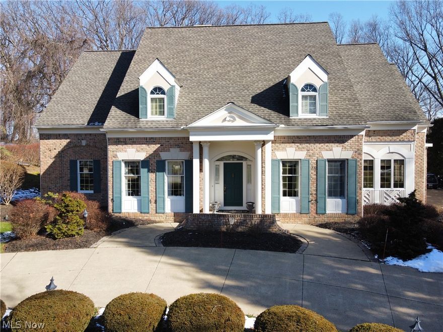 Exceptional all brick cape cod on over 1.5 wooded ac in Bath Twp presents superior quality & remarkable detail throughout.  This home imitates authentic Greek architecture w/pillared front entry, decorative cornices, extensive crown mldgs.  Gracious foyer w/stacked dental crown mldg & parquet floors flanked by formal liv & din rms. Liv rm offers inspiring arched niche shelving & glass French doors leading to library w/cherry built-ins. Luxurious FF owners suite boasts vaulted ceiling, Fr doors w/transom windows to outdoor patio area, WIC, & glamour bath w/jetted tub & marble floors.  Engaging, sunken two sty great rm highlights wall of windows, gas fpl, wet bar, built-ins, view of staircase & second floor, & access to patio.  Expansive kitchen features island/br bar, planning station, walk-in pantry, R/O sys, & sun filled eating nook.  Laundry w/utility sink & built-in ironing board & half bath conveniently located.  Adj staircase to guest/teen ste w/full bath.  2nd floor offers two spacious bedrms & J-N-J bath.  Finished lower level fam rm w/home theater sys, billiards area, half bath, rec lights, 2 walk-in closets, & ample storage.  Add'l notables incl. 9' ceilings, 6 panel doors, 3 c. heated gar w/tile floor, roof '14, HVAC '13, a/c in guest ste '20, water softener '16, pool heater '17, well pump '13, pool tile update '16, pool fence painted '22.  Oversized in-ground pool by Classic Pools. Gazebo. Extensive landscape w/lights, perennials, & sprinkler sys.  Revere schools.